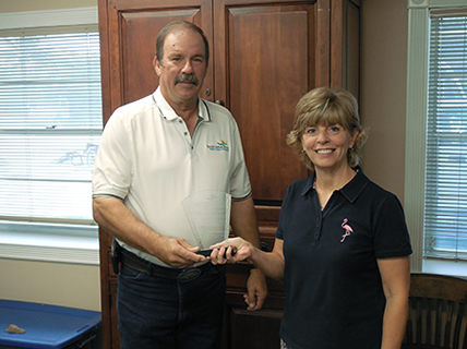 President Stephen Hinkle presents Office Administrator Holly Rigsby with award for 10 years of service.